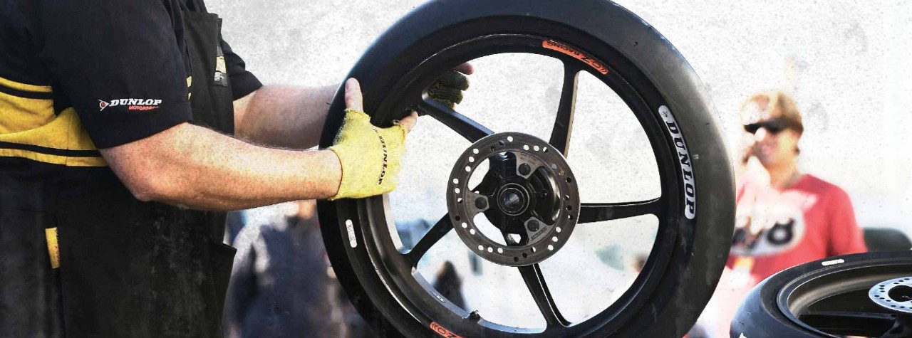 Dunlop race engineer holding racing tyre