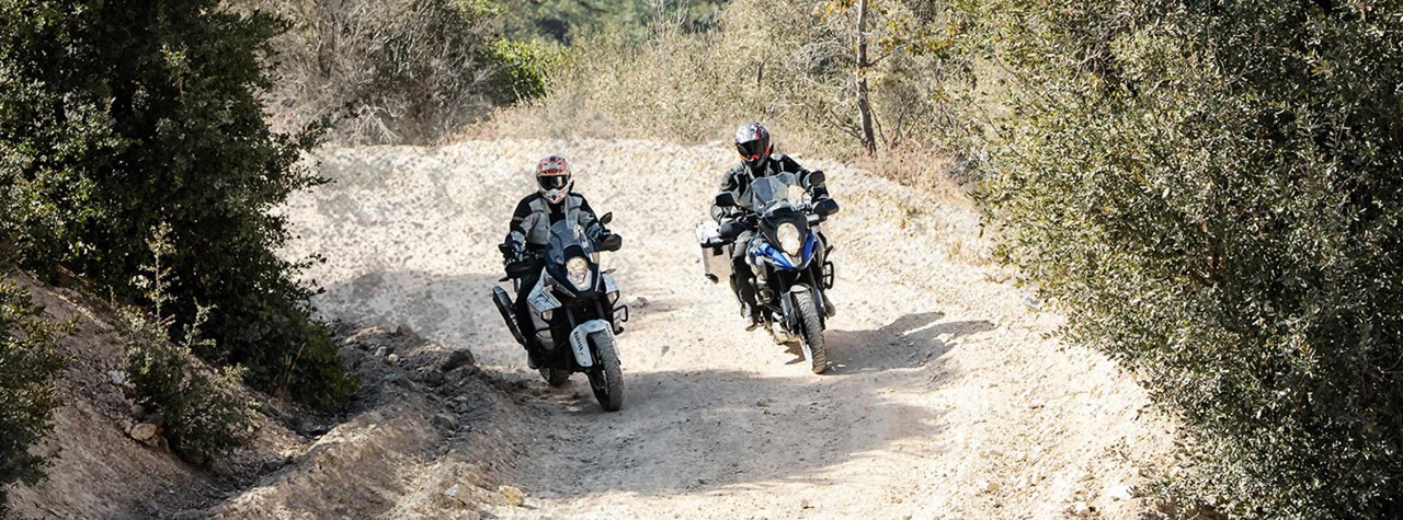 BMW 1200 GS riders on a dusty track on Dunlop Trailmax Mission tyres