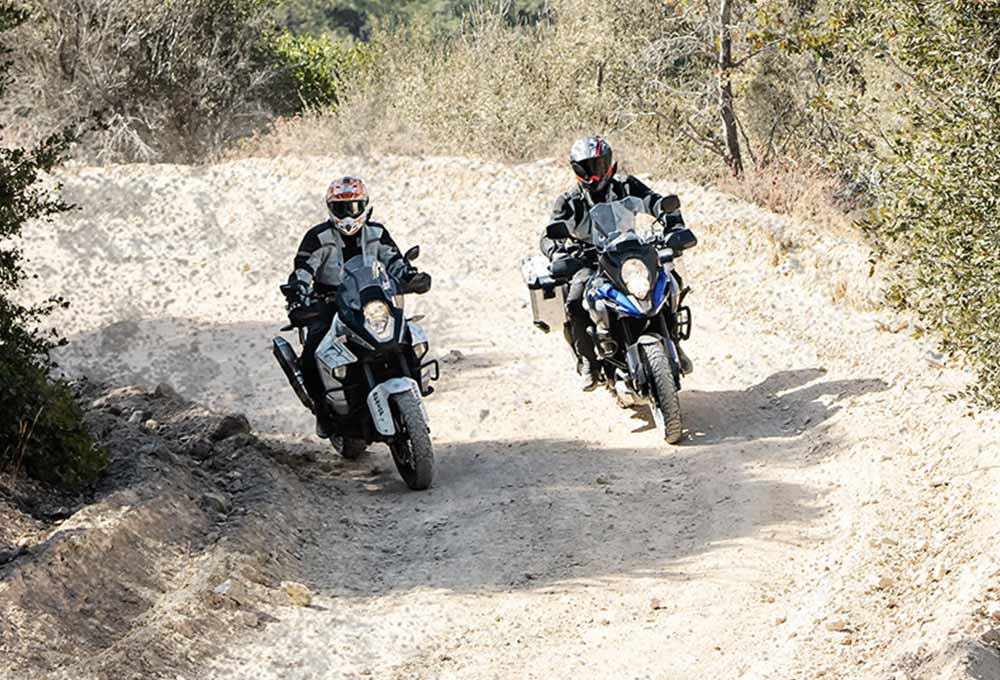 BMW 1200 GS riders on a dusty track on Dunlop Trailmax Mission tyres