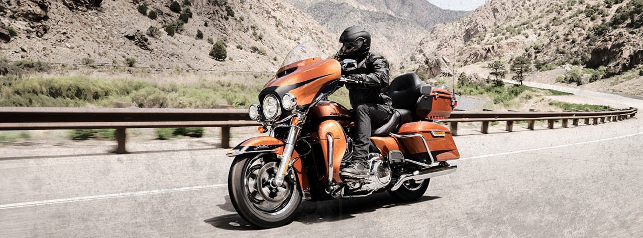 Harley-Davidson biker riding on Dunlop tyres through mountains